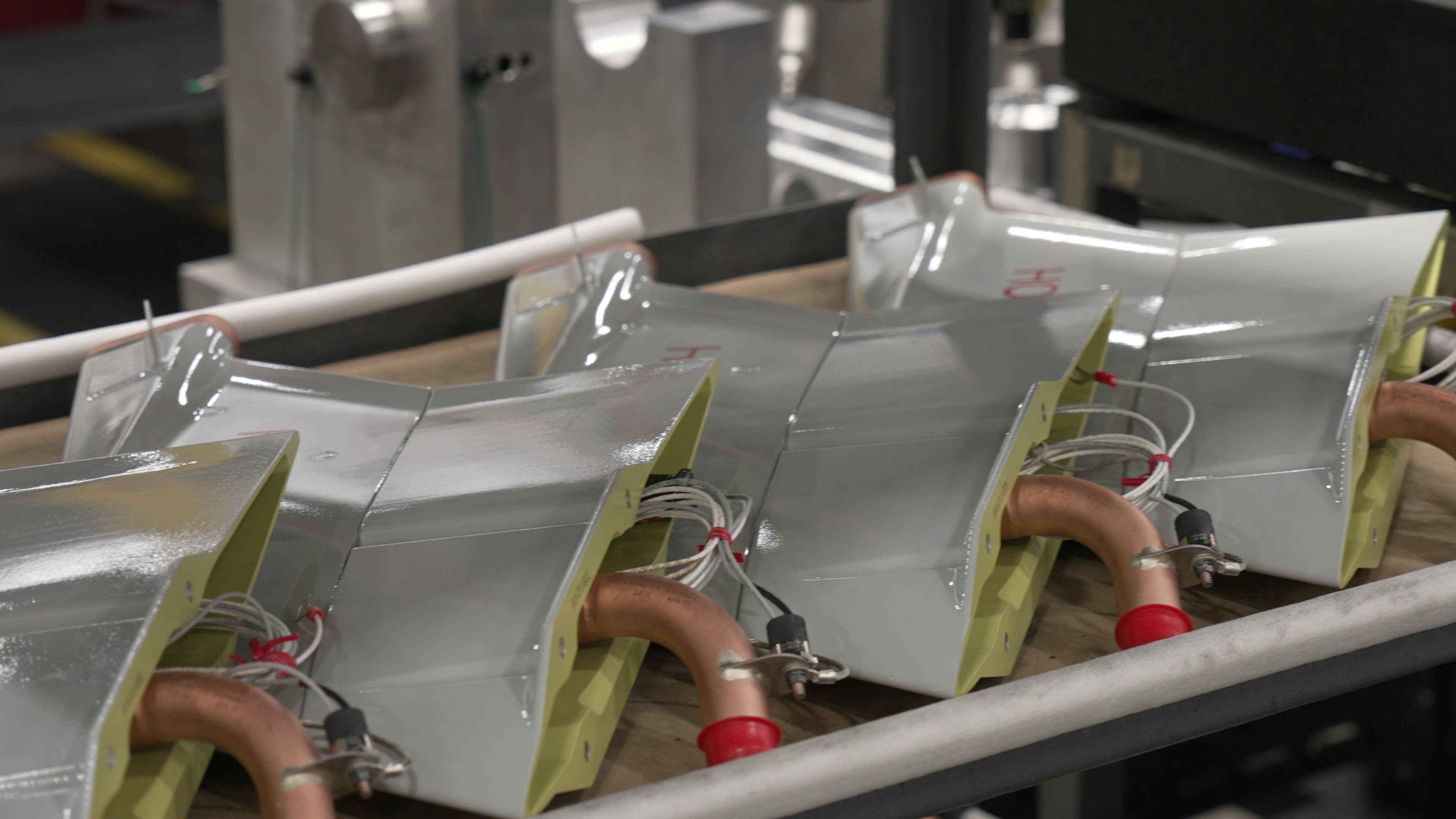 Curved machined parts stored on a rack